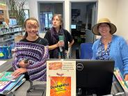 Librarian and two volunteers at circulation desk