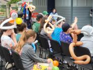 children and adults wearing balloon hats